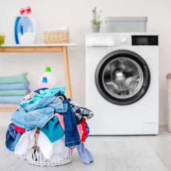 heap-clothes-washing-basket-standing-floor-near-washing-machine-light-bathroom_156881-4184